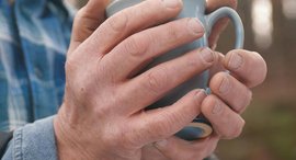 Hände halten Teetasse