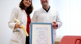 ßrztin und Arzt mit Urkunde